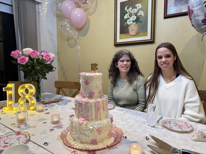 Elegant white cake with gold flower piping and delicate detail work