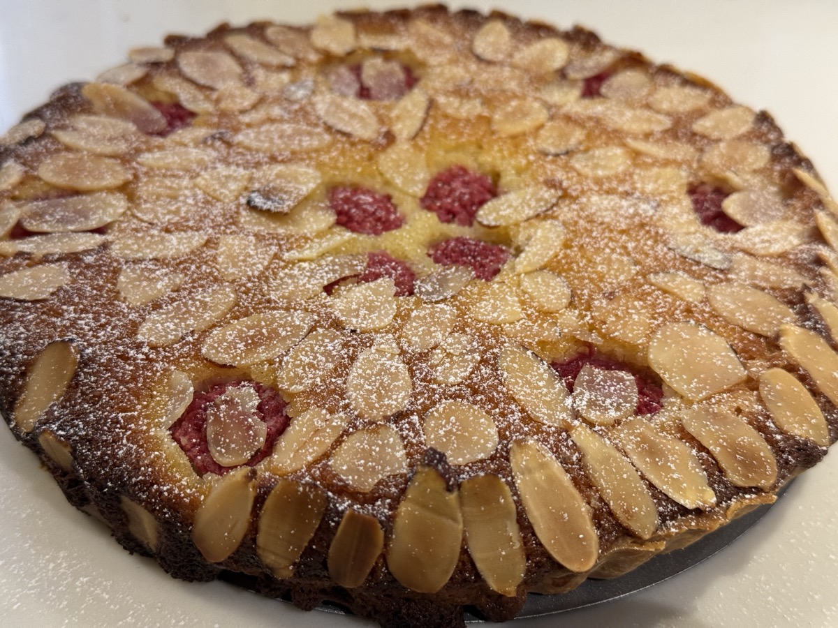 Almond and raspberry tart with delicate petal pattern