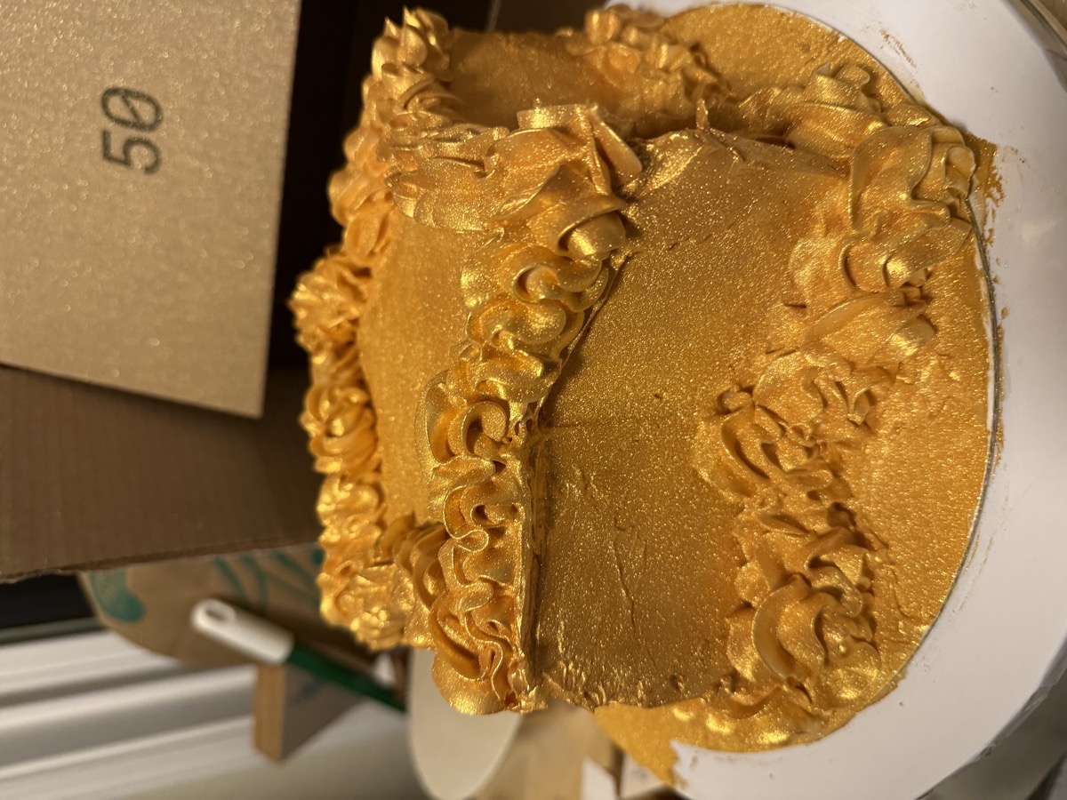 Stunning all-gold celebration cake with golden rosette piping